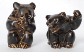 A pair of Danish Royal Copenhagen black bear figurines, one with raised paw both being stamped to