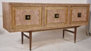 An original 1950`s formica low sideboard dresser raised on tapered supports. The left cupboard