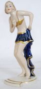 An Art Deco Royal Dux porcelain figurine by Elly Strobac.  Modelled as a dancing girl raised on