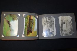 A vintage postcard album with several early 20th century American postcards and others.