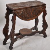 A Victorian Jacobean Revival solid oak folding occasional table. Raised on shaped carved legs with