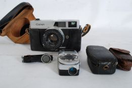 A Canon Canonet vintage SLR camera having original lens. Together with lightmeter, accessories amd
