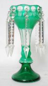 A Green moulded glass table lustre, having shaped stem with terraced foot and hung with prismatic