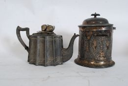 A decorative chase decorative silver plate teapot together with a similar biscuit barrel with lid