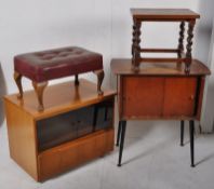 A vintage 1950's cabinet on ebonised tapering legs, a faux leather footstool, teak hi-fe cabinet and
