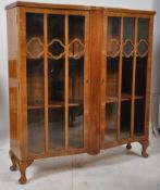 A 1930's Art Deco walnut bookcase display cabinet. Raised on cabriole legs with double doors