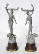 A pair of French spelter and bakelite menu holder figurines. The bakelite socles having brass