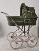 A 20th century large green corderoy silver cross pram in good condition with working hood, sat on