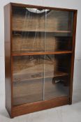 A good quality solid mahogany 1940's library bookcase having double twin glass sliding doors with