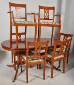 A Georgian style yew wood dining table and chairs. The chairs comprising 4 standard and 2 carvers.