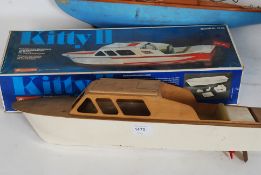 A vintage wooden model boat kit called Kitty II together with a blue hull pond yacht
