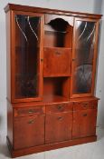A Georgian style yew wood display cabinet. The base with cupboards and drawers, above a glass
