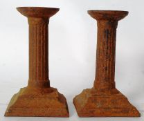 Pair of cast iron candle sticks roman numerals to underside of base MDCCLXIII for 1763 together with
