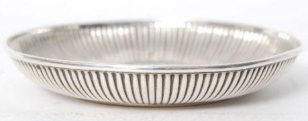 A hallmarked silver pin dish with ribbed edge