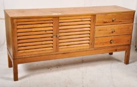 A 20th century pine low sideboard in the Danish style having slatted doors. Raised on square