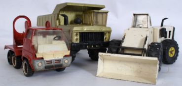 Three vintage Tonka toy vehicles including a Loader, cement mixer, and digger.