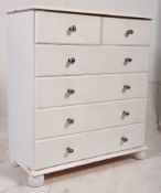 A 20th century painted pine 2 over 4 chest of drawers being raised on bun feet having decorative