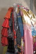 A large collection of theatrical fancy dress costumes to include Victorian style dresses, jackets,