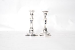 A pair of silver plated copper candlesticks.