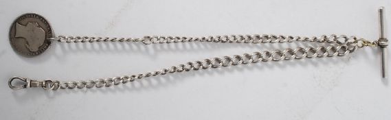 A hallmarked silver albert pocket watch chain and bar having 1854 one shilling coin bearing young