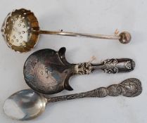 A silver hallmarked caddy spoon of rococo form together with a hallmarked 1910 coronation spoon