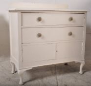 A 1930's painted shabby chic Queen Anne revival tallboy chest of drawers desk being raised on