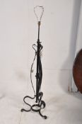 An early 20th century cast iron adjustable standard lamp of scrolled form. 116cm tall (to adjustable