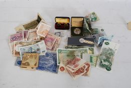 A collection of money and banknotes to include two British £1 notes, vintage threepenny coins