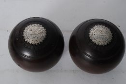 A pair of Victorian silver mounted presentation bowling balls, each being inset with plaques with