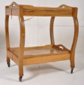 A good quality hardwood butlers trolley having twin trays that remove. All raised on shaped supports