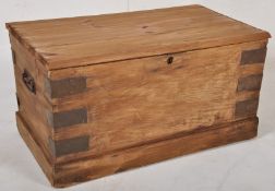 A 19th century style pine blanket box / travel trunk chest. Exterior metal brackets and handles with