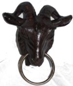 A cast iron goats head, with large heavyweight horns to top and ring pull to nose.