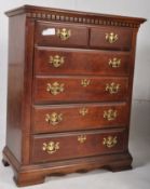 A Georgian style two over four chest of drawers, each drawer being fitted with brass handles. H110cm