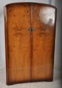 A 1940,s Queen Anne revival Art Deco walnut double wardrobe. Twin doors with open storage within /