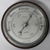 An early 20th century Smiths of England compensated wheel barometer. Oak cased with glass front