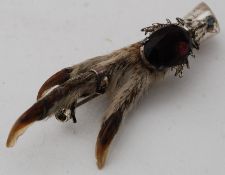 A Scottish silver talon brooch, formed from an eagles talon. The silver mount with amethyst stone