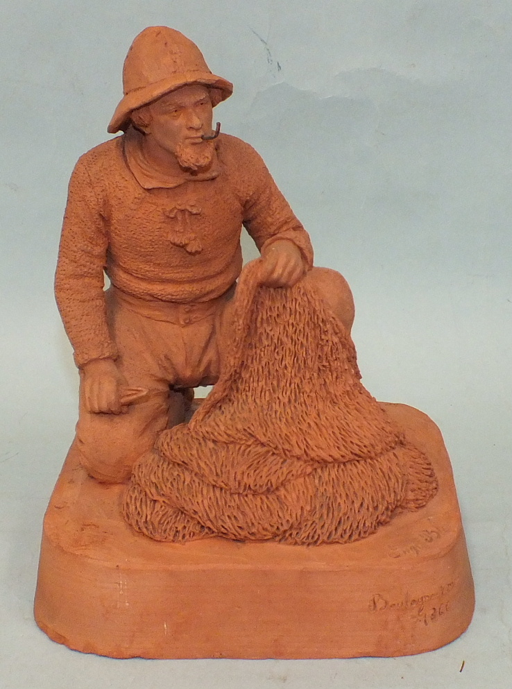 Eugene Blot, a terracotta figure of a fisherman repairing a net, incised `Boulogne Sur Mer 1866`