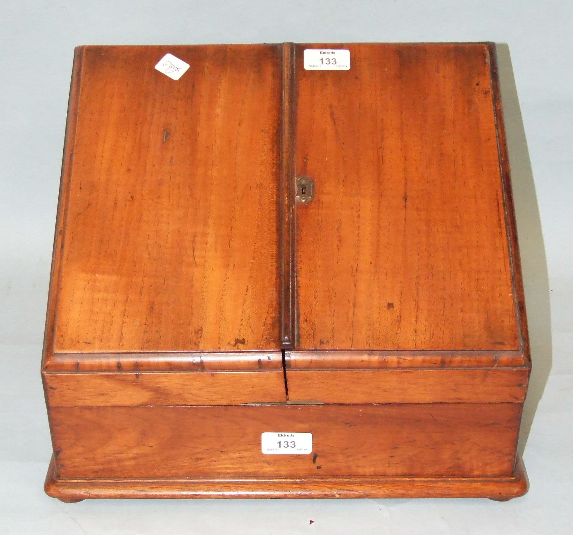 A late-19th/early-20th century mahogany stationery cabinet fitted with a pair of hinged sloping
