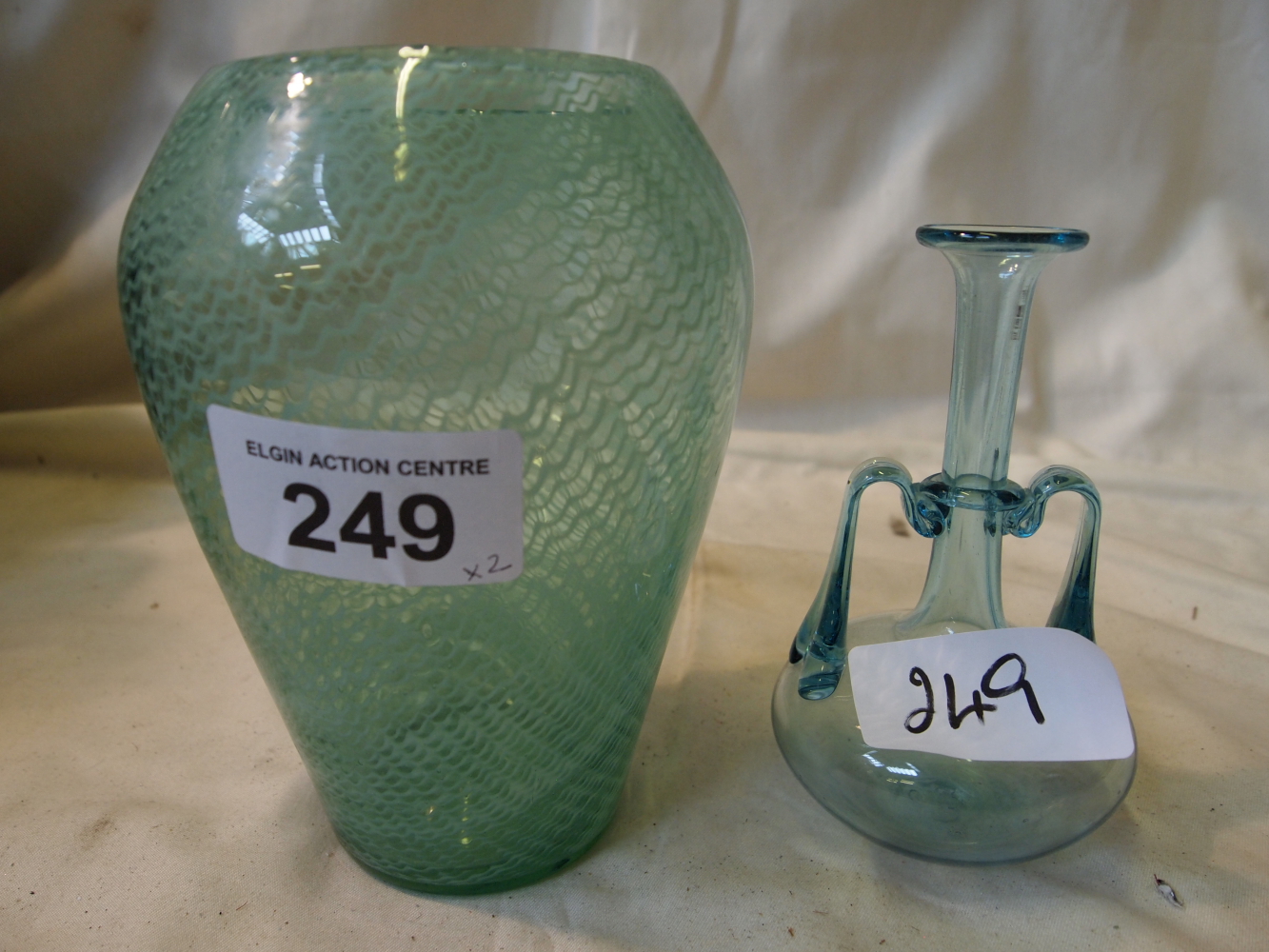 Sale Item:    2 GREEN GLASS VASES   Vat Status:   No Vat   Buyers Premium:  This lot is subject to