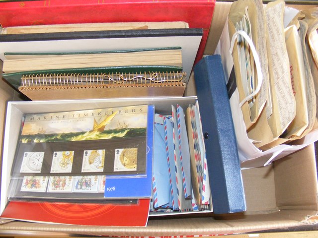 A carton of mixed world and GB stamps on envelopes, in packets, in albums etc