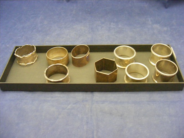 A collection of silver napkin rings and two silver plated