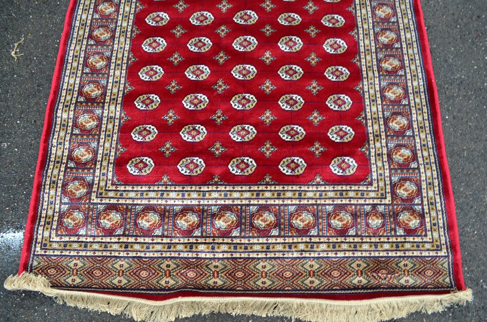 Red ground Kashmir rug with a Bokhara design, 200cm x 140cm - Image 2 of 5