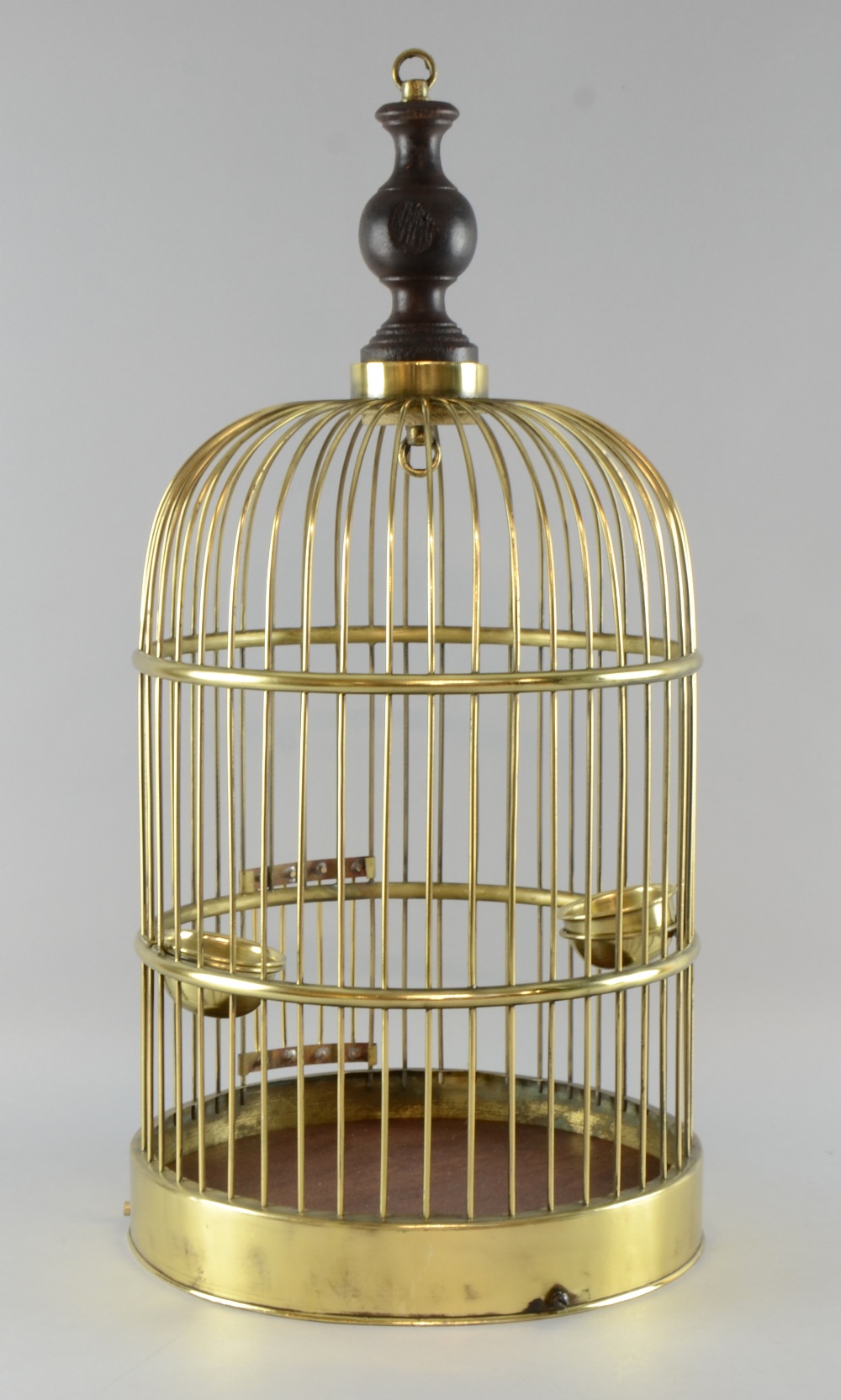 Brass parrot cage with two brass wells, wood base 23in. (58cm)
