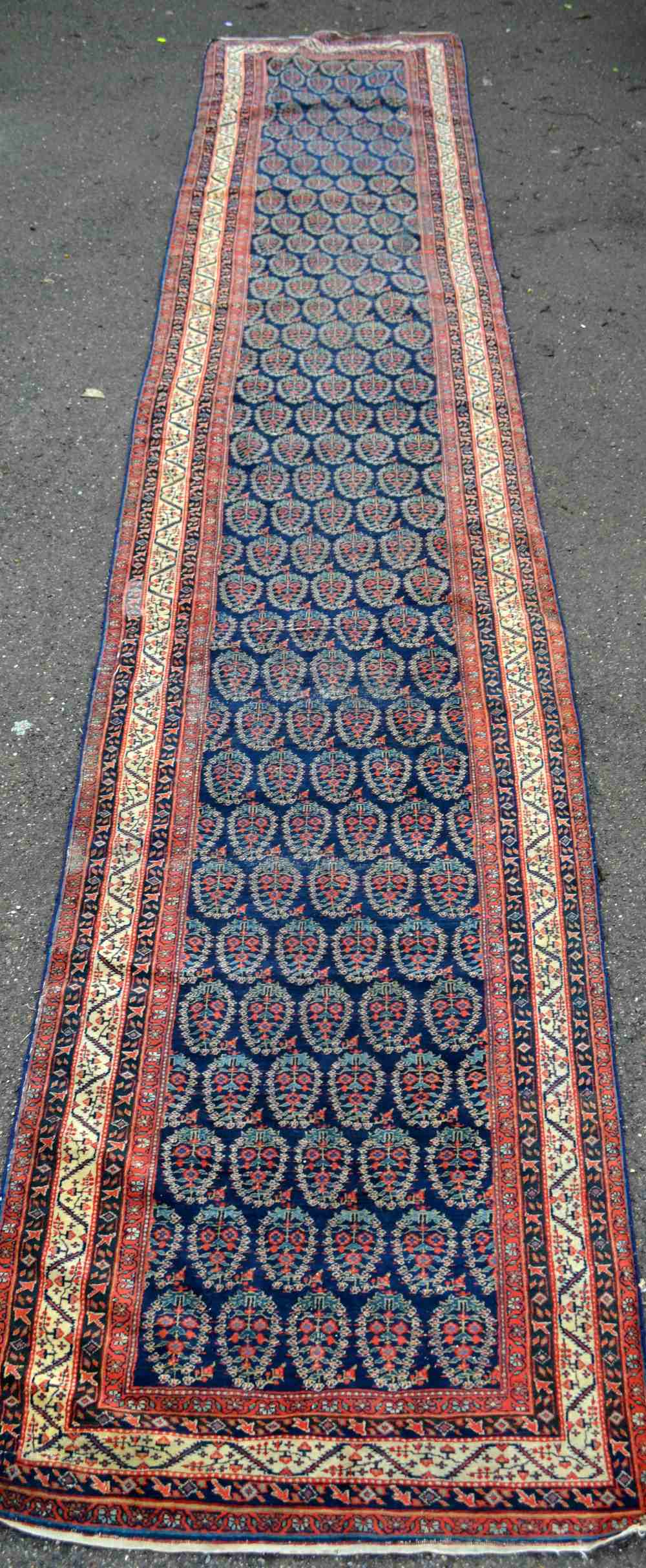 Persian blue ground runner, multiple borders, centre decorated with repeating foliate forms, 200"