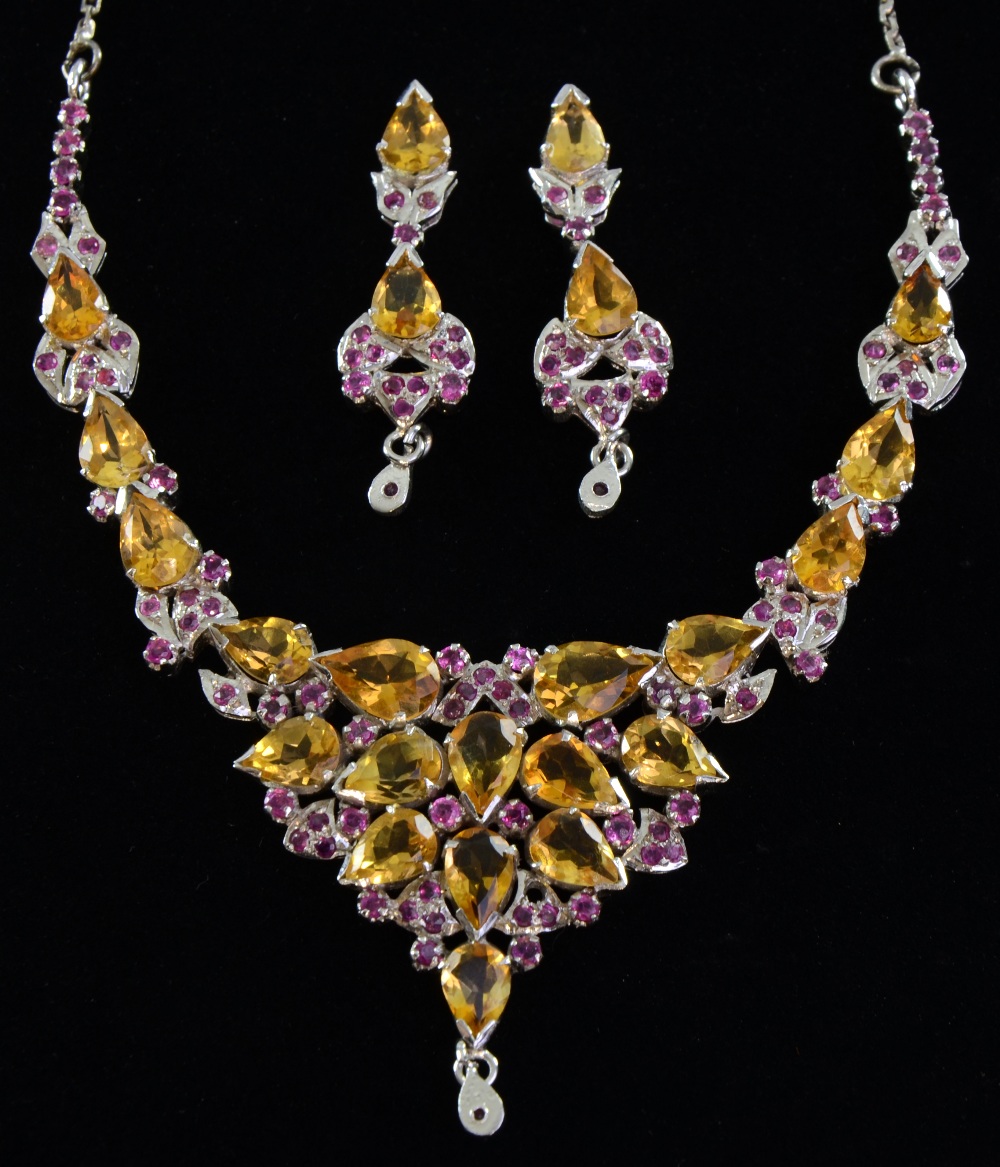 A citrine and ruby set necklace and matching drop earrings unmarked white metal,Good condition,