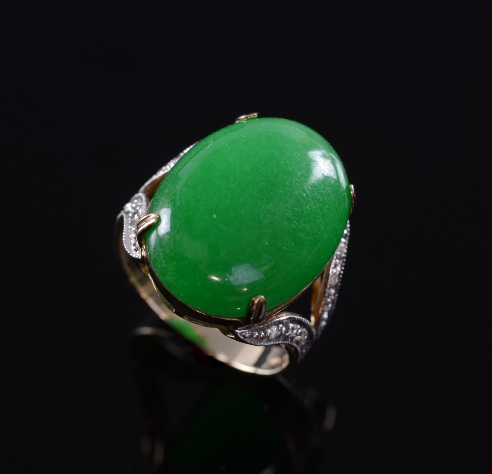 A dyed Jade cabouchon ring, with diamond set shouldersGood condition