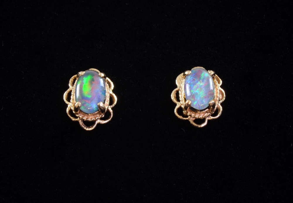 A pair of black opal set ear studs in 9ct gold