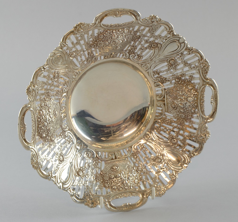German silver basket with pierced and scrolling decoration on four shaped feet, `800` standard, 8.