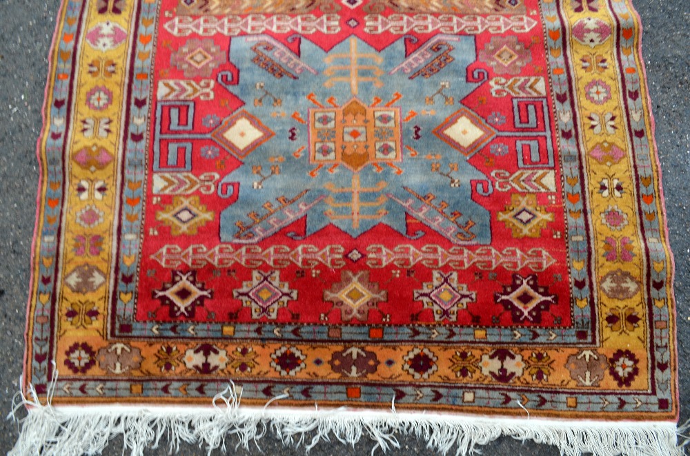 Persian red ground carpet, main yellow border the centre decorated with a pair of shaped blue - Image 3 of 5
