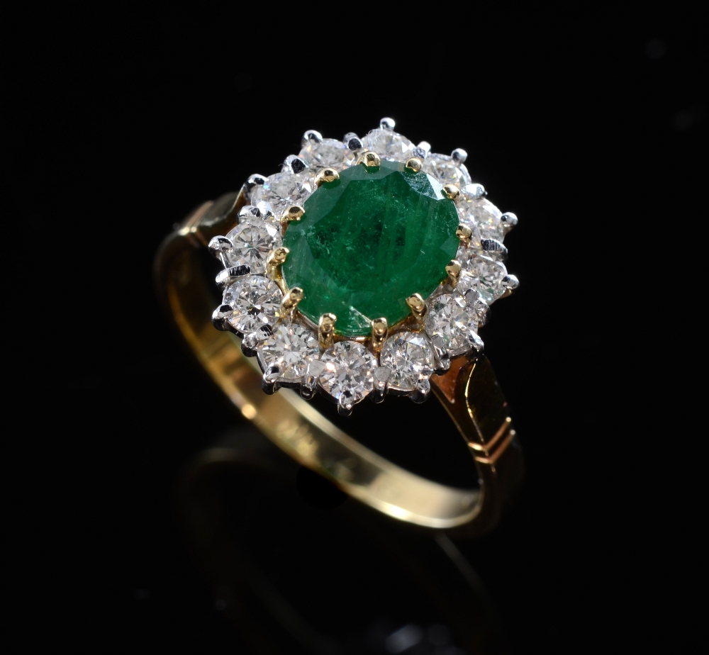 Emerald and diamond cluster ring yellow and white gold mount 18ctOval cut emerald dimensions: 8.95 x